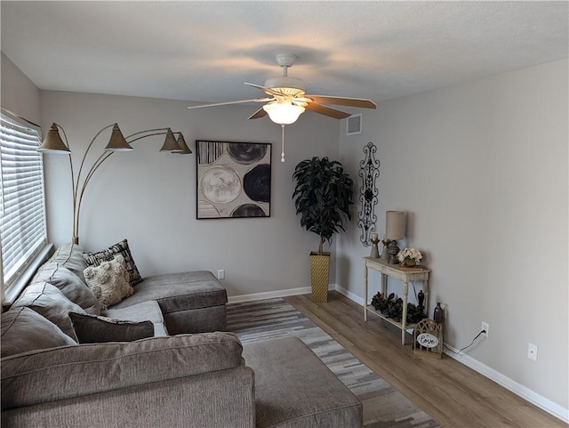 living room featuring ceiling fan and wood-type flooring