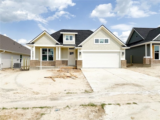3148 Margaret Rudder Pkwy, Bryan, TX 77808 - craftsman house featuring brick siding, driveway, cooling unit, and a garage