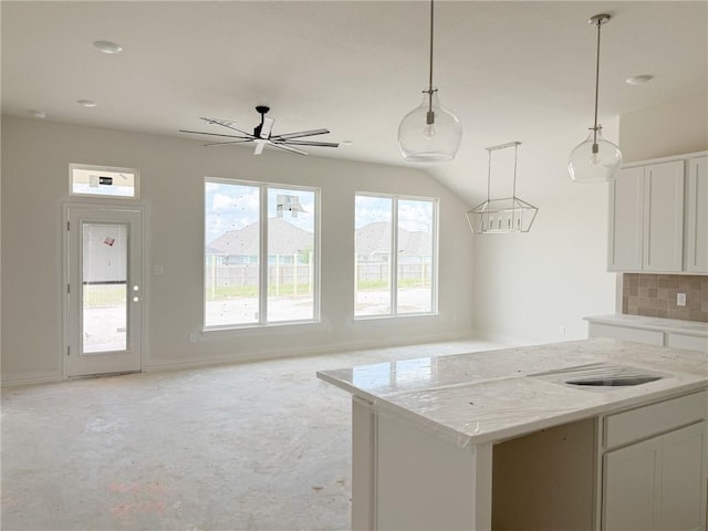 3148 Margaret Rudder Pkwy, Bryan, TX 77808 - kitchen featuring white cabinetry, decorative backsplash, open floor plan, decorative light fixtures, and lofted ceiling