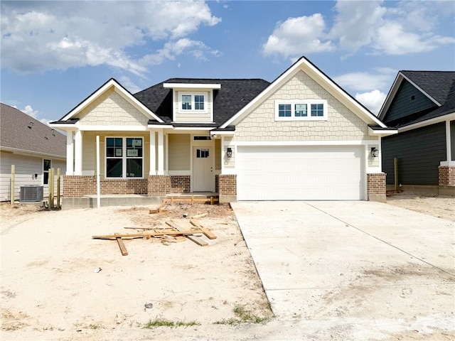 3148 Margaret Rudder Pkwy, Bryan, TX 77808 - craftsman-style home with brick siding, central AC unit, driveway, a porch, and an attached garage