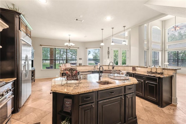 11376 Majestic Dr, Montgomery, TX 77356 - kitchen with a sink, a kitchen island with sink, a chandelier, premium appliances, and hanging light fixtures