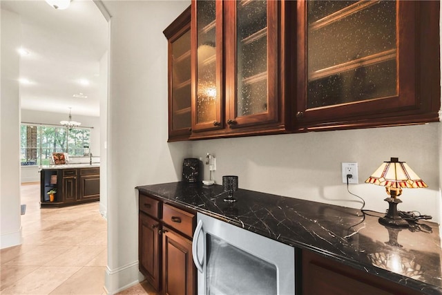 11376 Majestic Dr, Montgomery, TX 77356 - bar area with wine cooler, baseboards, light tile patterned floors, and a chandelier