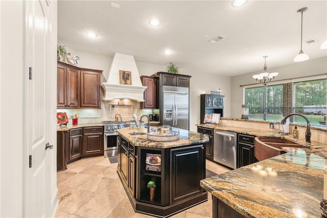 11376 Majestic Dr, Montgomery, TX 77356 - kitchen with high quality appliances, a sink, custom range hood, decorative backsplash, and recessed lighting