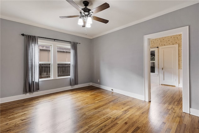 spare room with light wood-style flooring, baseboards, and ornamental molding