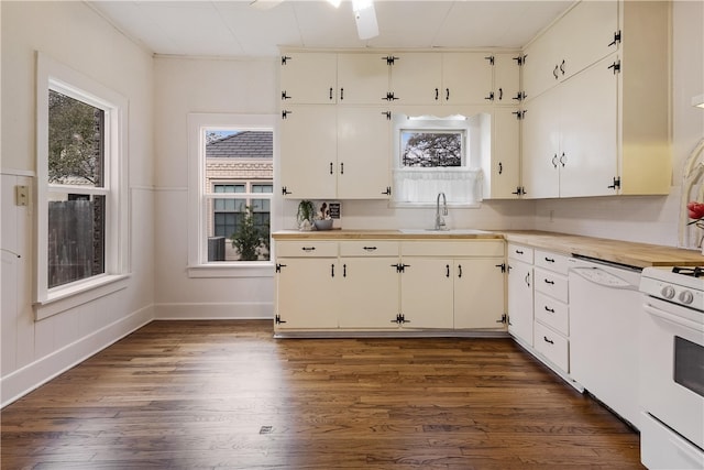 kitchen with white appliances, dark wood-style floors, a sink, light countertops, and white cabinetry