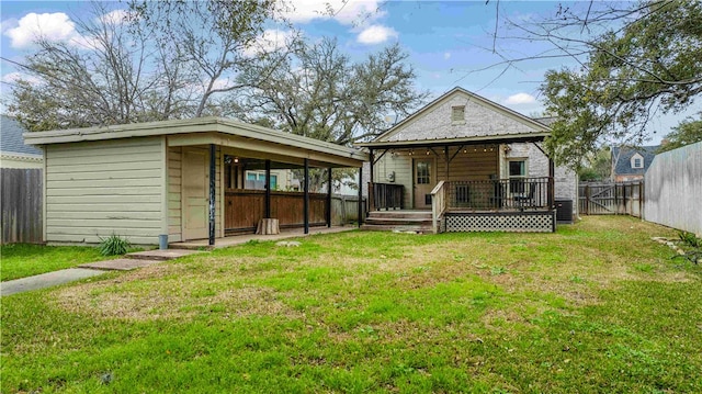 rear view of property featuring a deck, a yard, a fenced backyard, and cooling unit