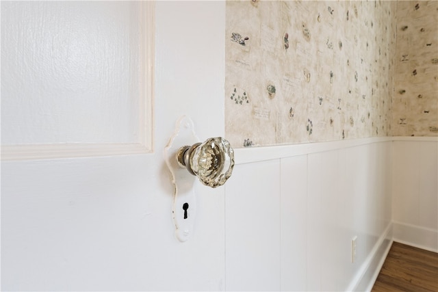 room details with a wainscoted wall and wood finished floors