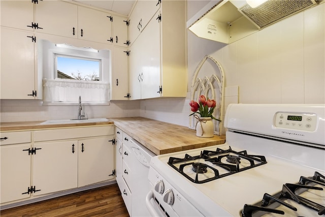 kitchen featuring a sink, white appliances, backsplash, and dark wood-style flooring