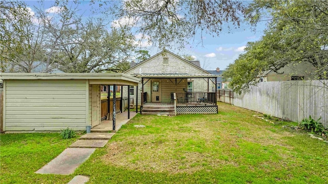 back of house with a deck, a yard, and a fenced backyard