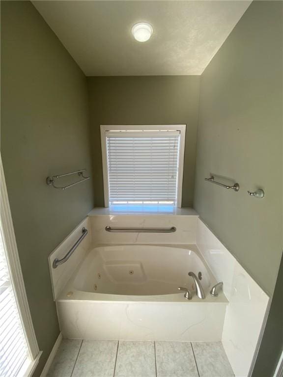 bathroom featuring a tub to relax in and tile patterned floors