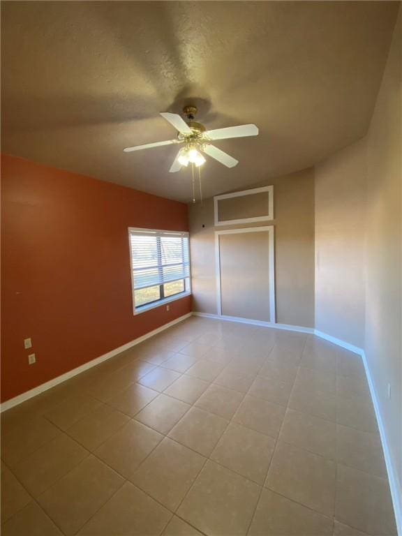 unfurnished bedroom featuring ceiling fan and light tile patterned floors