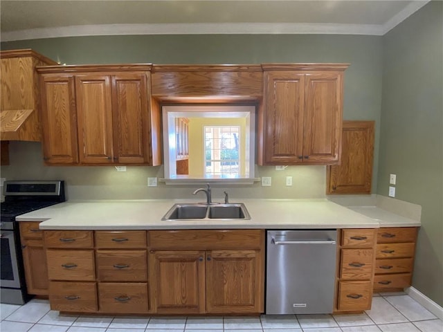 kitchen with crown molding, sink, light tile patterned floors, and stainless steel range oven