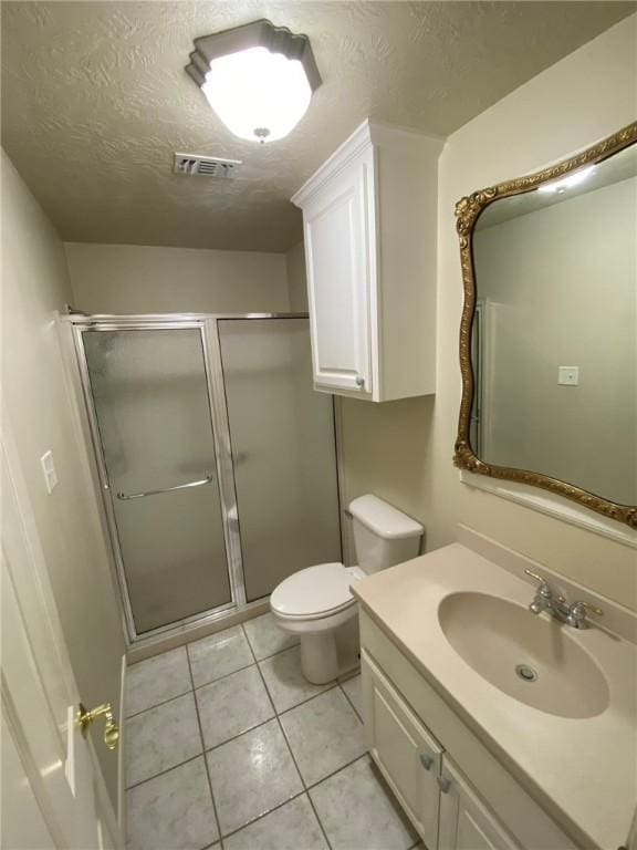 bathroom featuring tile patterned floors, an enclosed shower, and a textured ceiling