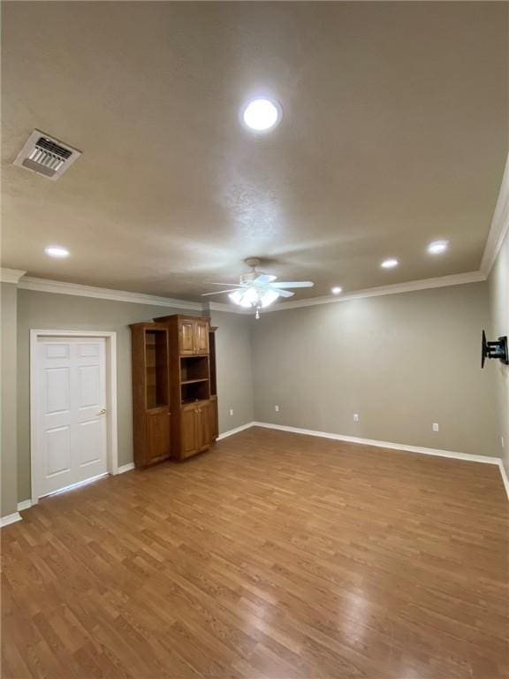 unfurnished living room with hardwood / wood-style floors, ceiling fan, and crown molding