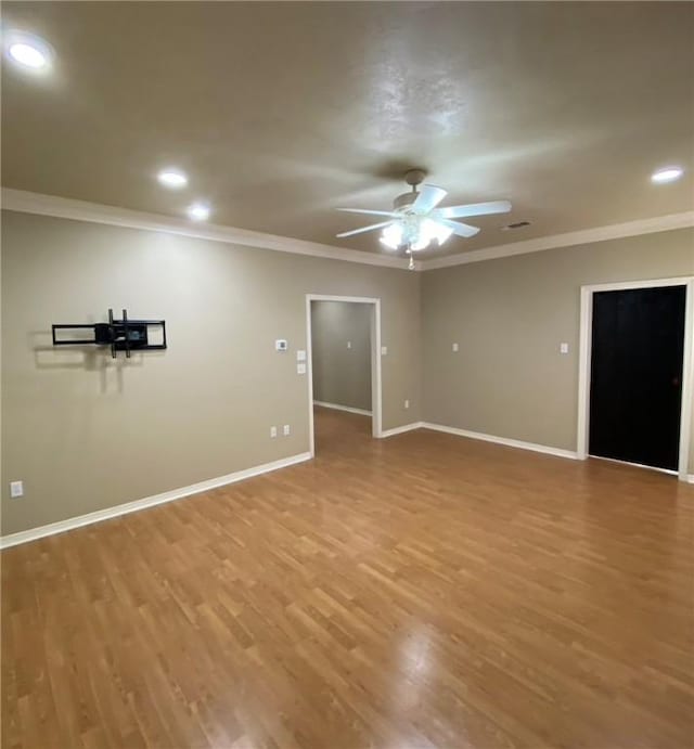 unfurnished room featuring ceiling fan, wood-type flooring, and crown molding