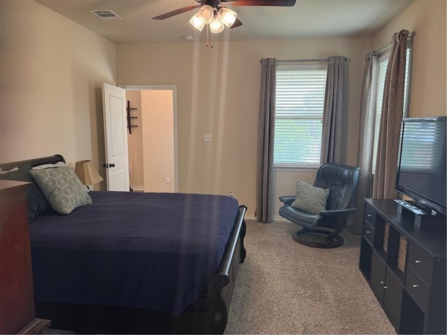 bedroom featuring a ceiling fan, visible vents, and carpet