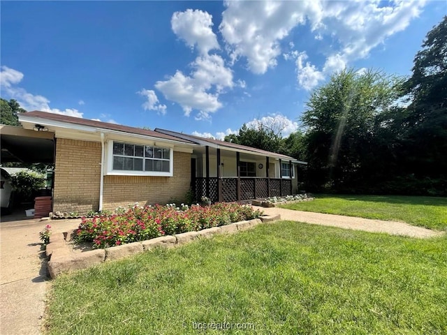 ranch-style home with a carport, a porch, and a front yard