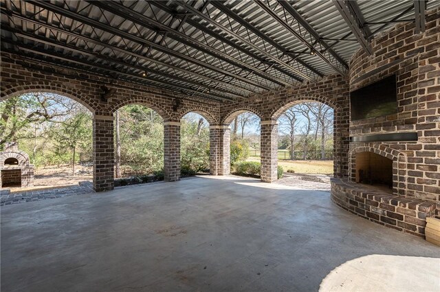 view of patio with an outdoor brick fireplace