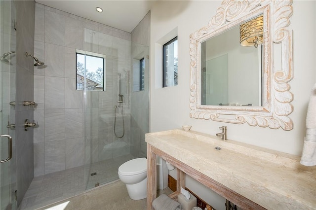 bathroom with a stall shower and toilet