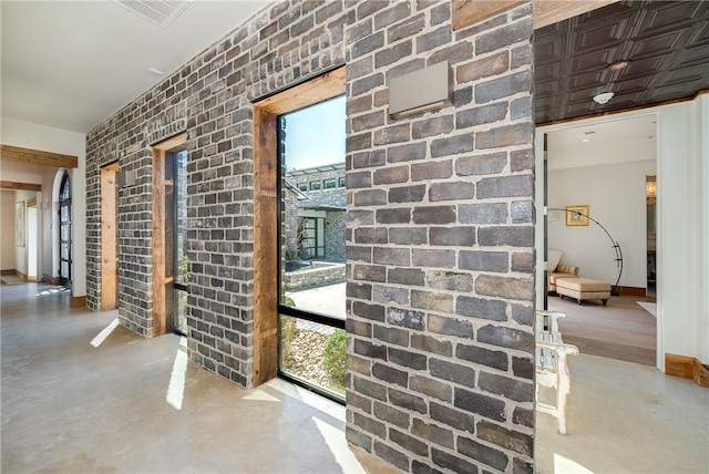 interior space featuring a wealth of natural light, visible vents, and concrete flooring