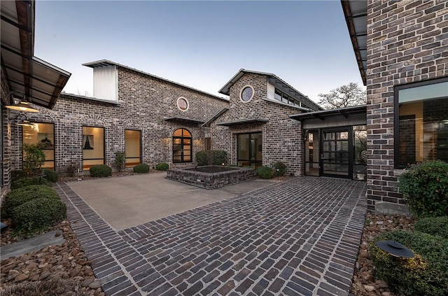 exterior space featuring a patio and brick siding