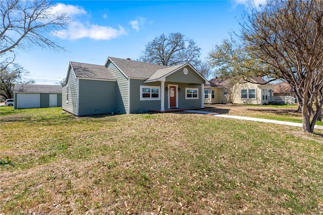 view of front of house with an outdoor structure and a front yard