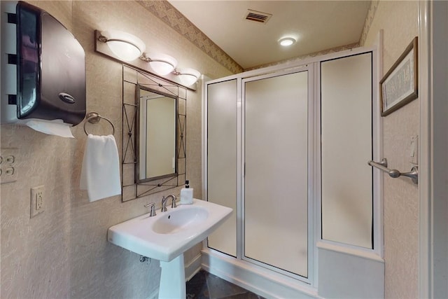 bathroom featuring a shower stall and visible vents