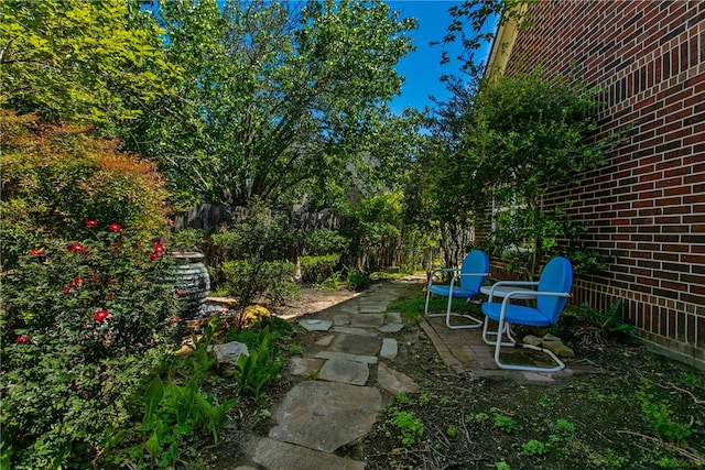 view of yard with fence and a patio
