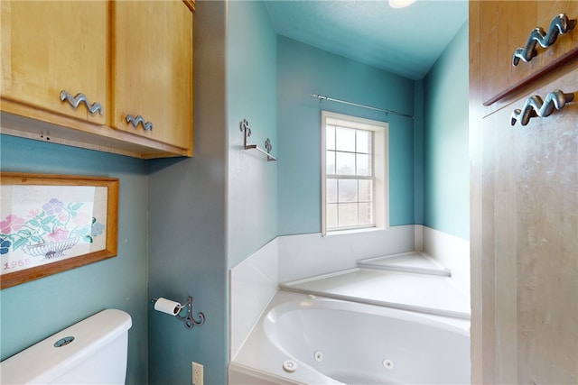 full bath with a whirlpool tub and toilet