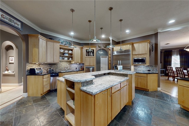kitchen featuring crown molding, open shelves, light brown cabinetry, a center island, and a sink