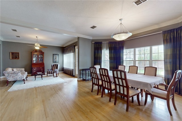 dining area featuring visible vents and light wood-type flooring