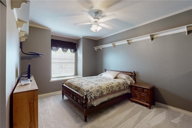 bedroom featuring light colored carpet, a ceiling fan, baseboards, and crown molding