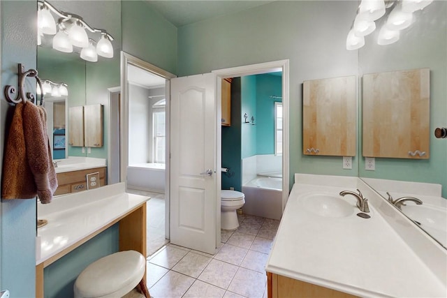 full bathroom with tile patterned flooring, a bath, toilet, and vanity