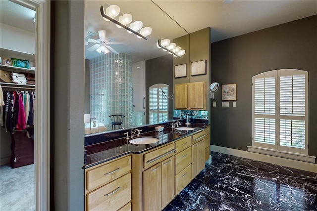 bathroom featuring double vanity, a sink, marble finish floor, and ceiling fan
