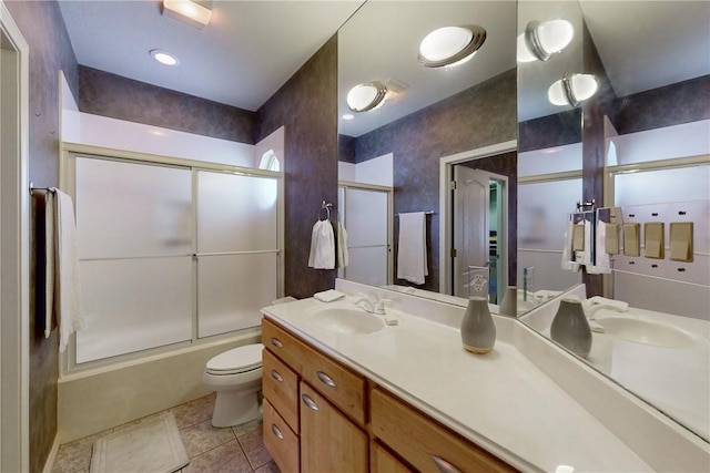 full bathroom featuring toilet, tile patterned floors, enclosed tub / shower combo, and vanity