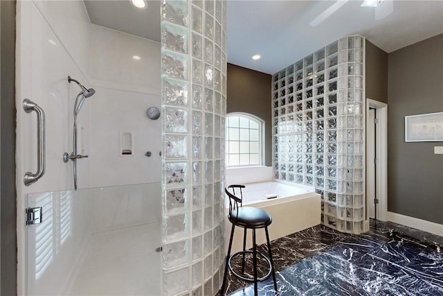 bathroom with marble finish floor, baseboards, recessed lighting, a walk in shower, and a bath