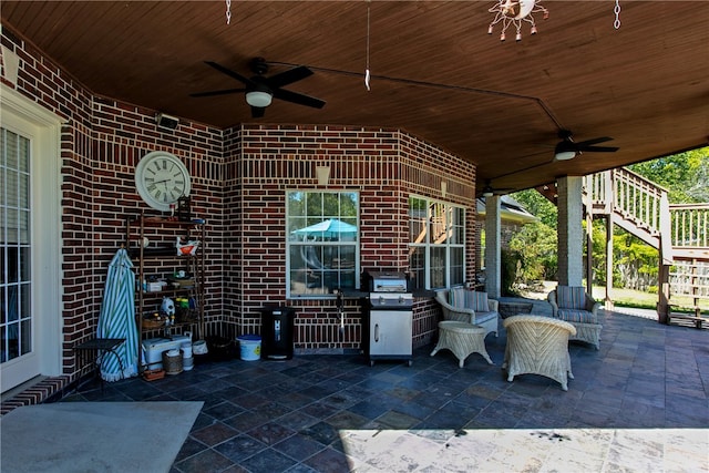 view of patio with stairs, ceiling fan, and grilling area