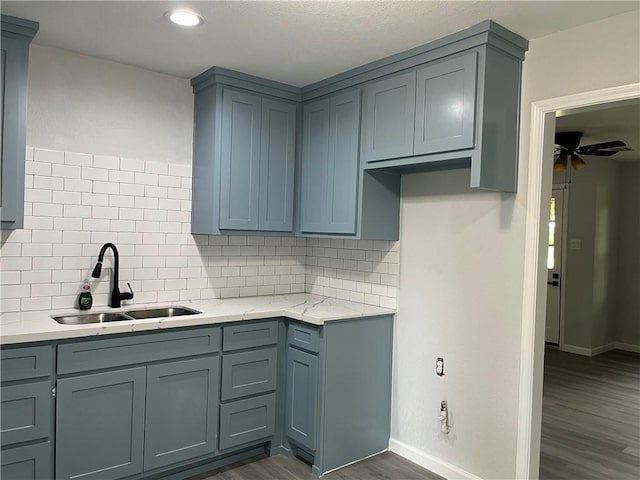 502 Willow Cir, Brenham, TX 77833 - kitchen with dark wood finished floors, ceiling fan, decorative backsplash, light stone countertops, and recessed lighting