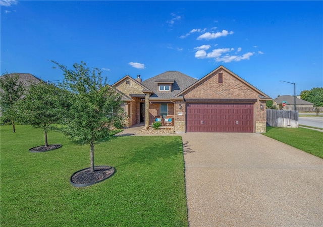 view of front of home featuring a garage and a front lawn