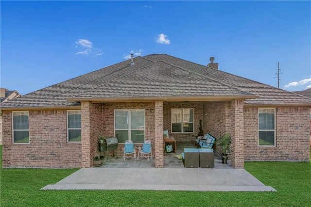 rear view of house with an outdoor living space, a yard, and a patio