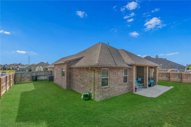 back of house with a lawn and a patio area