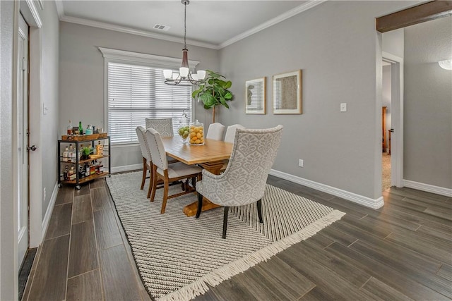 dining area with dark hardwood / wood-style floors, an inviting chandelier, and ornamental molding