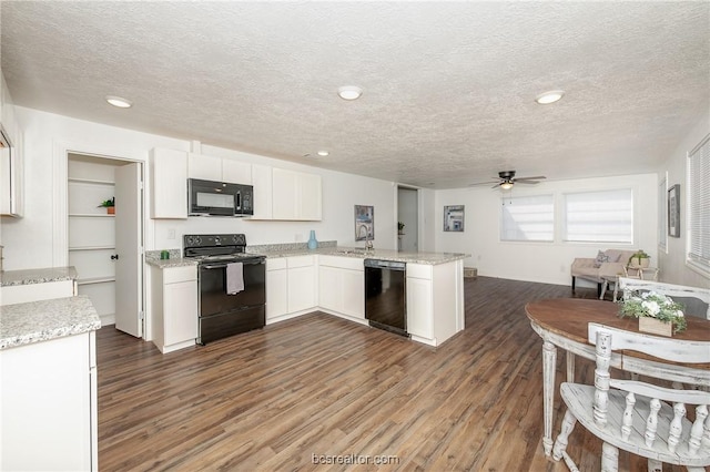 kitchen featuring kitchen peninsula, a textured ceiling, ceiling fan, black appliances, and white cabinetry