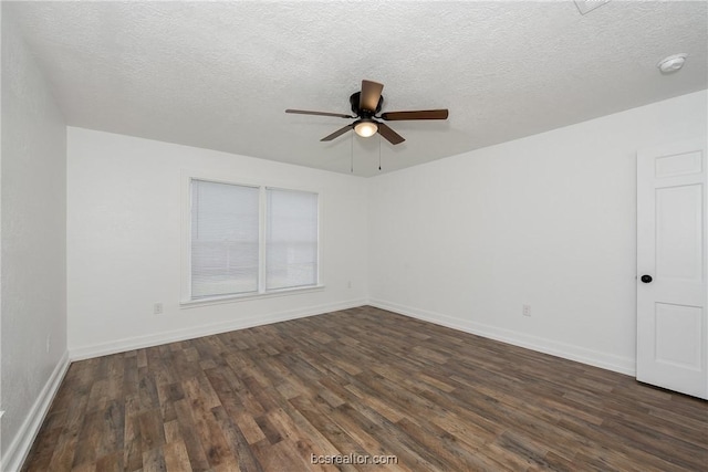 spare room with dark hardwood / wood-style floors, ceiling fan, and a textured ceiling