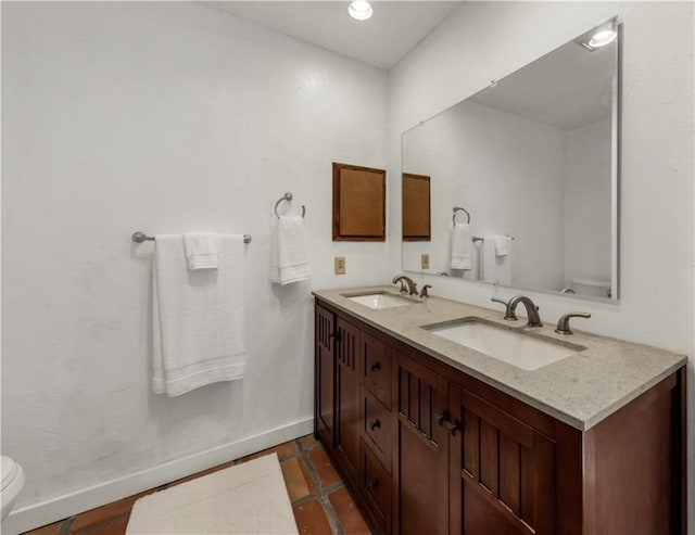 1205 King Arthur Cir, College Station, TX 77840 - full bathroom featuring toilet, double vanity, and baseboards