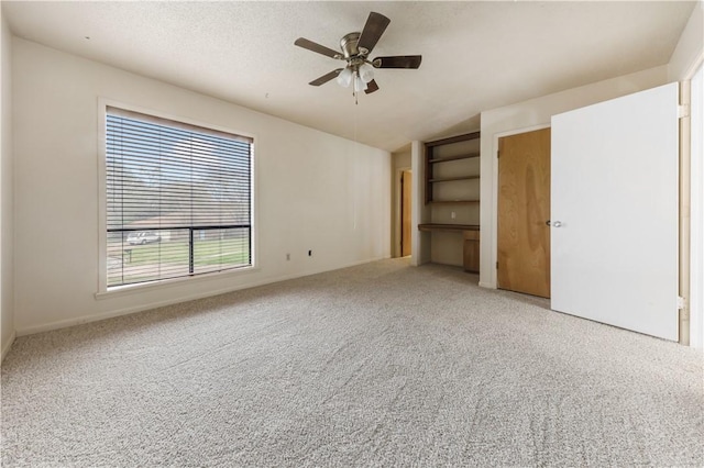1205 King Arthur Cir, College Station, TX 77840 - unfurnished bedroom featuring vaulted ceiling, carpet floors, ceiling fan, and baseboards