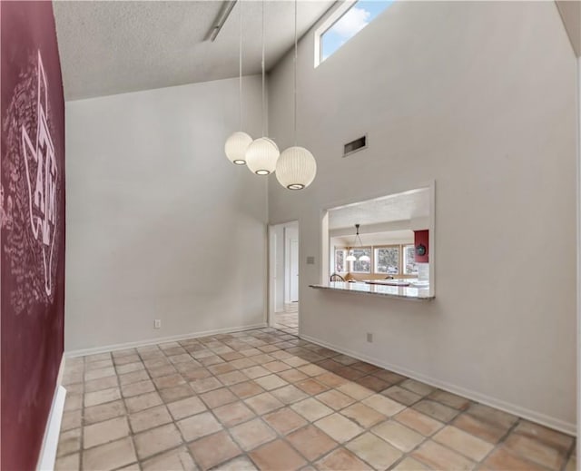 1205 King Arthur Cir, College Station, TX 77840 - unfurnished room featuring high vaulted ceiling, plenty of natural light, baseboards, a textured ceiling, and a chandelier