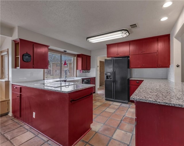 1205 King Arthur Cir, College Station, TX 77840 - kitchen featuring black refrigerator with ice dispenser, a peninsula, red cabinets, backsplash, and a textured ceiling