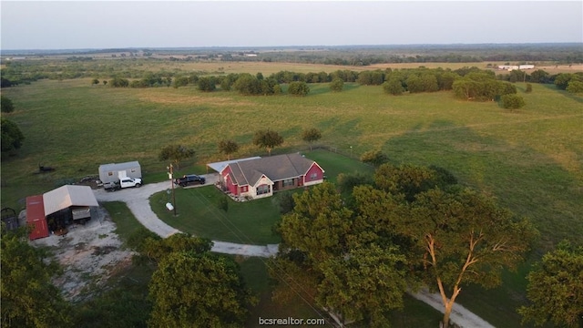 birds eye view of property with a rural view