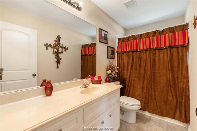 bathroom with tile patterned flooring, vanity, toilet, and curtained shower